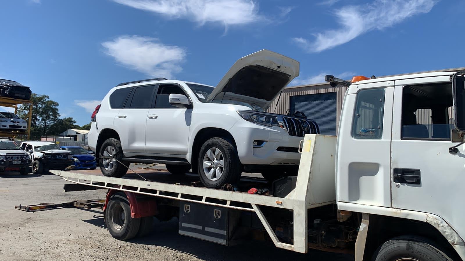 White SUV on a tow truck tray in Comprehensive Towing’s media photo